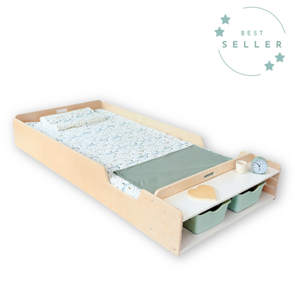 Maple wood Twin Montessori floor bed with integrated bedside shelf, designed to support toddler independence and safe sleep transitions