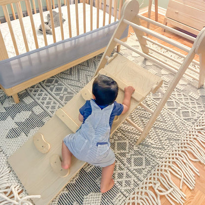 baby crawling and climbing using his baby feet and hands to climb helping with gross motor skills