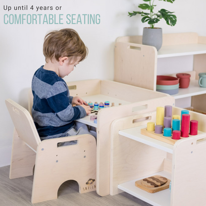a 4 year old sitting on a weaning table and chair working on beads activity. You can also see a large shelf and a small shelf on the side to hold material and toys
